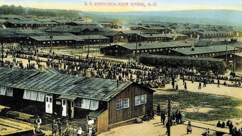 Historical postcard of a wooden barracks camp for refugees during World War I