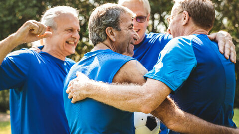 Round of men hugging each other after sports