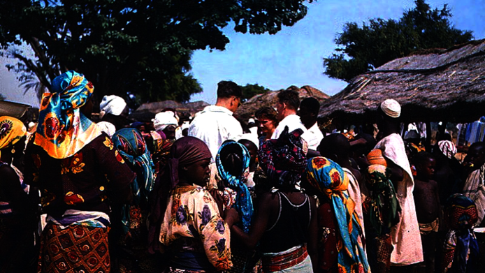 Market events in Zaranda, Nigeria 1958: local population and colonial officials in exchange