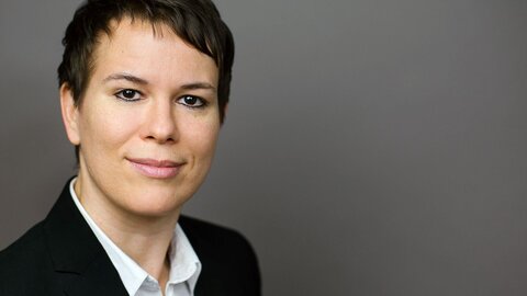 Portrait photo of a young female researcher with short dark hair.