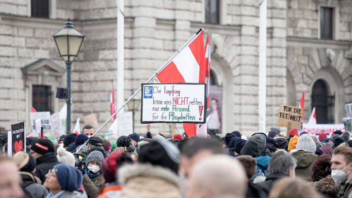 Demonstrators with Austrian flags and signs protesting against the coronavirus vaccination