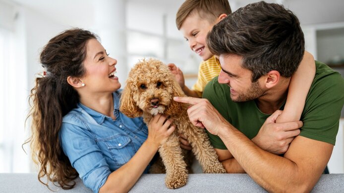 Happy small family with dog 