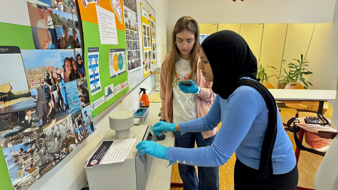 Students replace an air filter cartridge.