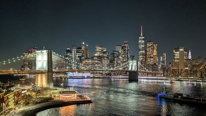 New York City skyline at night with Brooklyn Bridge and Financial District
