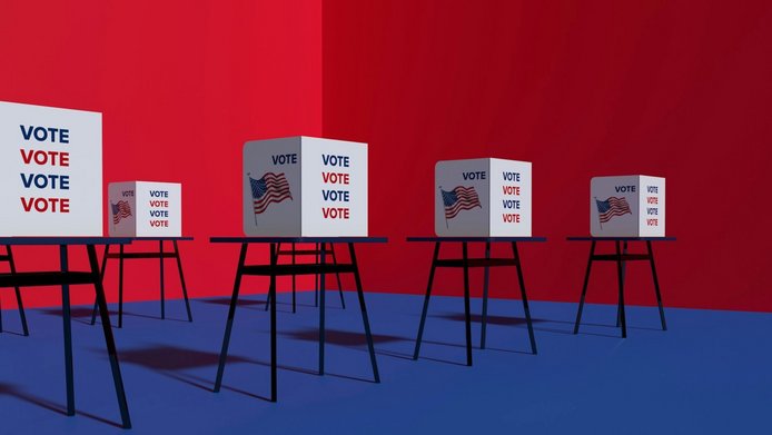 Grafische Darstellung von US-Wahlboxen auf Tischen mit der Aufschrift "Vote" vor blau-rotem Hintergrund