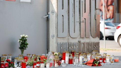 Many candles and flowers in front of a school entrance following a shooting rampage