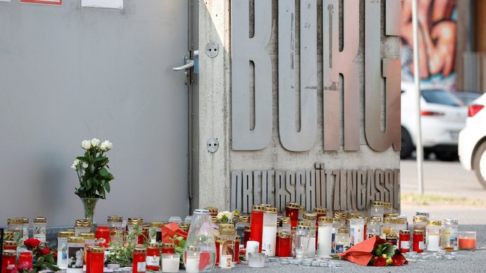 Many candles and flowers in front of a school entrance following a shooting rampage