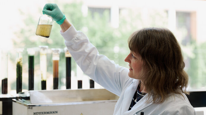 Forscherin im Labor untersucht Mischkulturen von Bakterien und Archaeen aus vier verschiedenen Biogasanlagen, die unterschiedliche Materialien vergären.